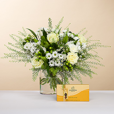 Aussi brillant qu'un diamant scintillant, nous vous présentons ce bouquet élégant, tout en blanc. Accompagné d'une boîte de délicieux chocolats Godiva Gold pour compléter le cadeau.