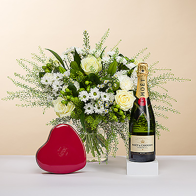 Aussi beau qu&#39;un diamant, nous vous présentons cet élégant bouquet tout blanc. 
Le bouquet est accompagné d&#39;une bouteille festive de champagne Moët & Chandon et d&#39;une boîte à cœur rouge classique remplie de chocolats belges Corné Port-Royal. C&#39;est le cadeau idéal pour toute occasion romantique.