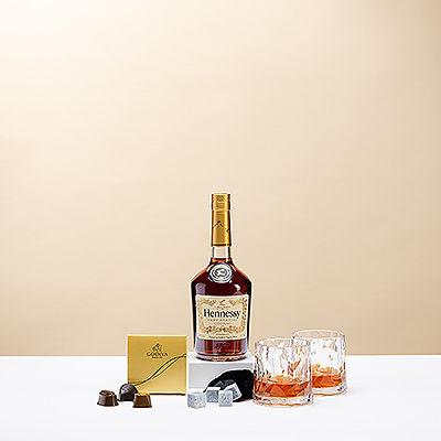 Appréciez le caractère fruité et intemporel de Hennessy V.S. autour d'un feu de cheminée lors d'une soirée froide avec des amis ou quelqu'un de spécial. Ce cadeau comprend une paire de verres Koziol Superglas lowball, beaux et résistants, et des glaçons en pierre ollaire qui ne fondent pas, afin de maintenir votre cognac on the rocks à la température idéale. Quatre chocolats Godiva dans une boîte en or constituent une délicieuse combinaison avec le cognac.